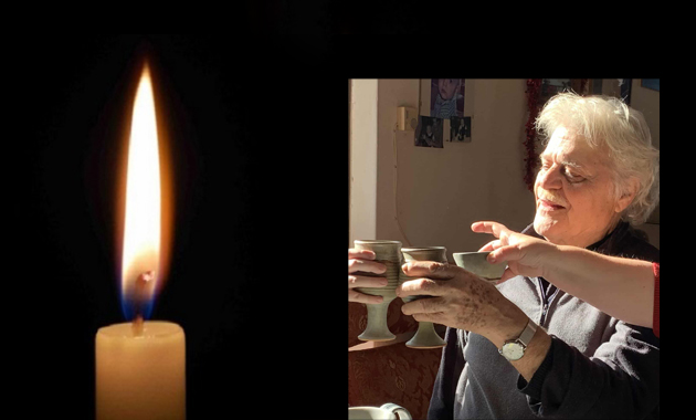 Candle flame and hands holding cups